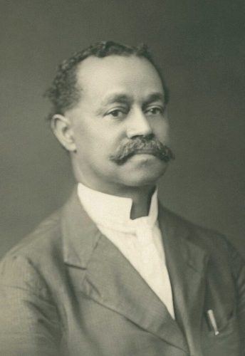 Black & white photo of a distinguished Black man with a moustache
